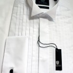 A wing collar dress shirt Fly fronted, plain bib. Double cuff, so cuff links required.
